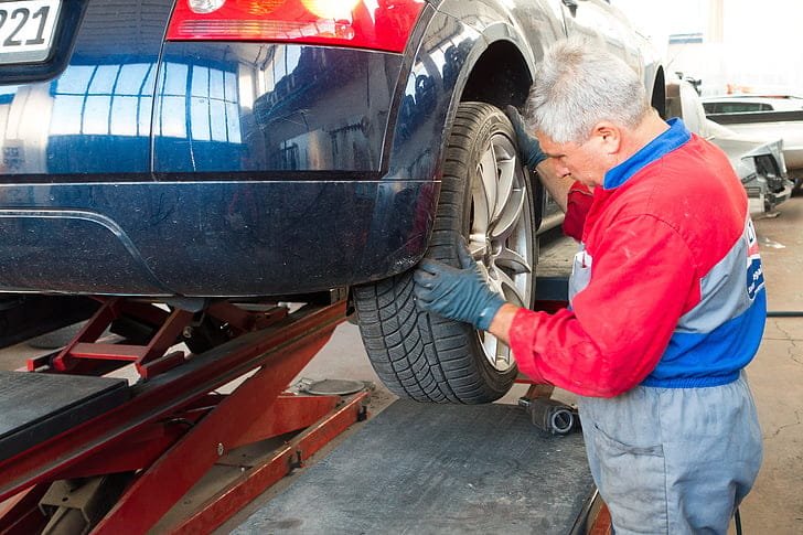 Technician performing a detailed vehicle inspection