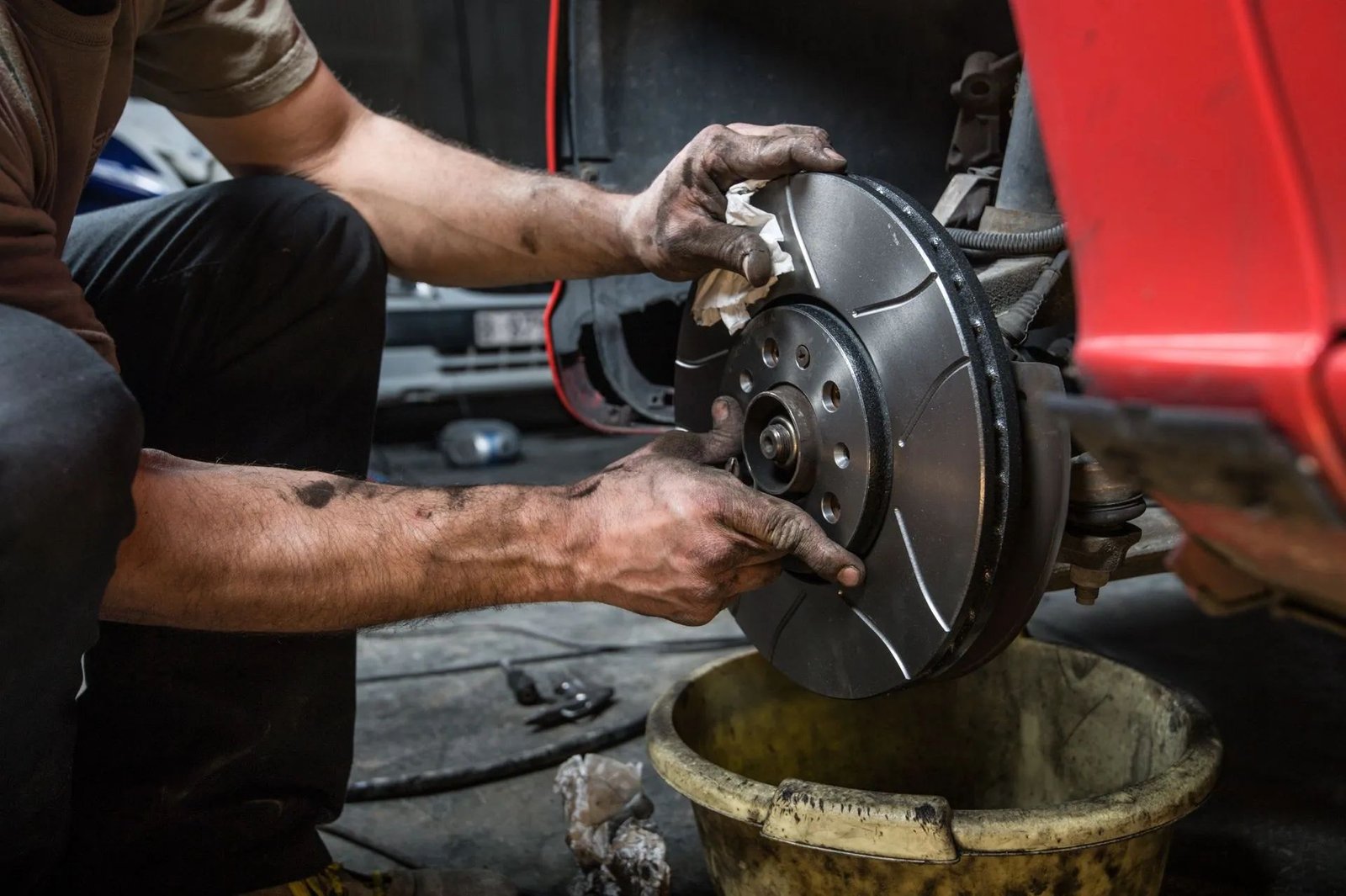 Technician performing a brake service on a disc rotor