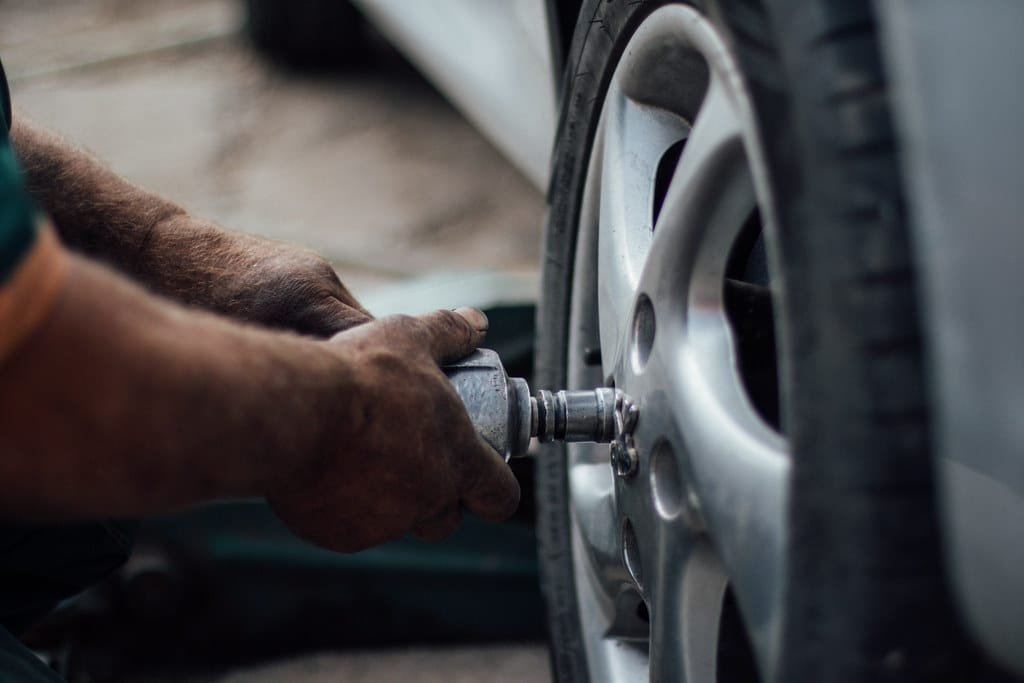 Technician servicing a vehicle tire and wheel