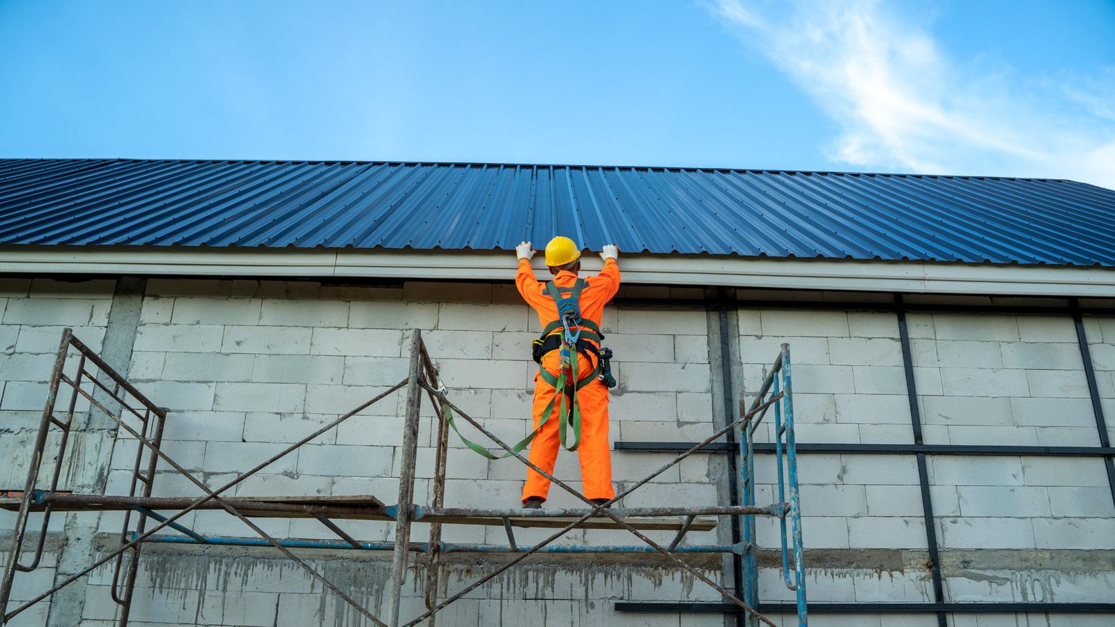 Roofing technician working safely on a roof after a storm