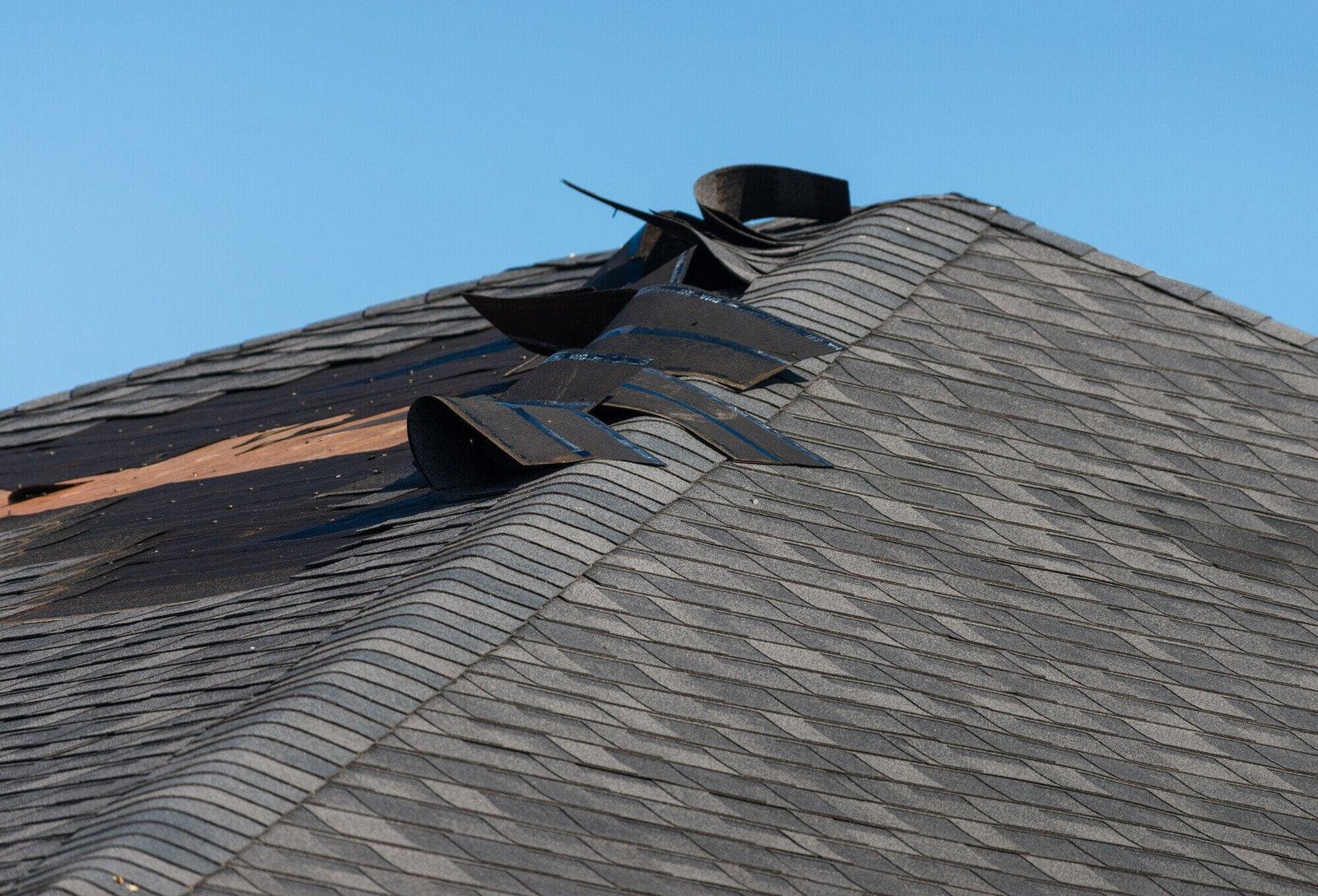 Before: roof with storm-related shingle damage (demo example)